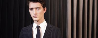 Portrait of a man wearing a suit, shirt and tie by BOSS
