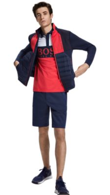 Man in blue and red jacket, logo polo, and navy shorts by BOSS menswear