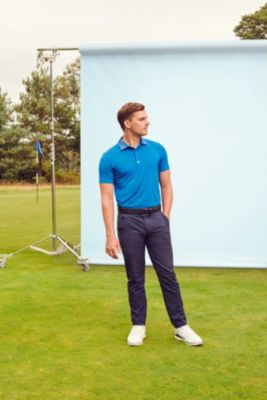 Professional golf player wearing a polo shirt and golf trousers by BOSS