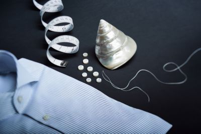 Shirt with buttons and thread on a table by BOSS