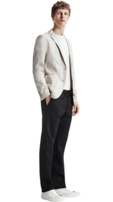 Men wearing white shirt, grey suit, black trousers and white shoes by BOSS