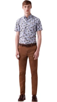 Man wearing printed shirt, brown trousers and brown shoes by BOSS