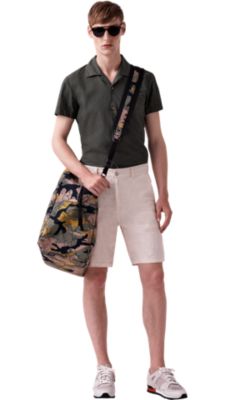 Man wearing green shirt, white pants by BOSS