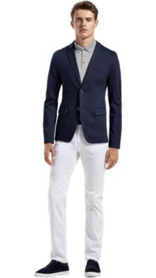 Men wearing grey shirt, blue blazer, white trousers and blue shoes by BOSS