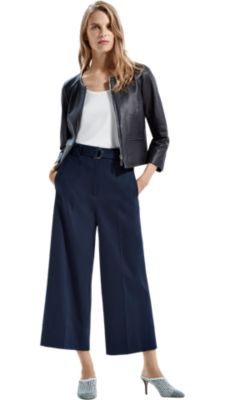 Women wearing blue leather jacket, white shirt, blue trousers and shoes by BOSS