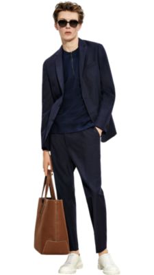 Man wearing blue jacket and trousers, white shirt and black shoes by BOSS