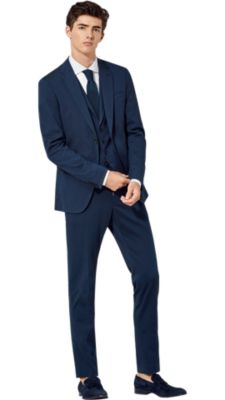 Man wearing blue jacket with grey trousers and red shoes by BOSS