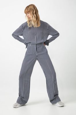 Female model wearing a shirt with stripes and trousers with stripes by HUGO