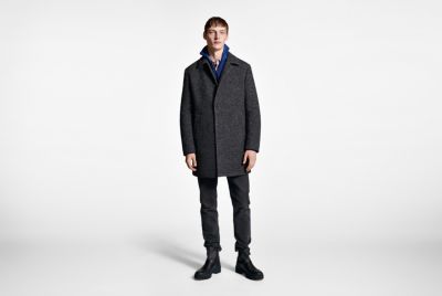  Male model wearing a grey coat and black trousers by BOSS