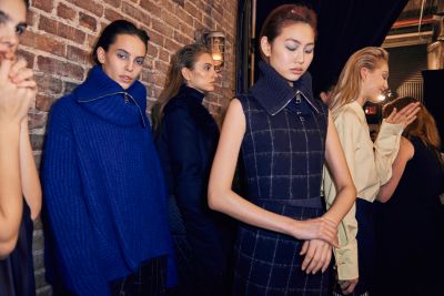 Models backstage in the line up to hit the runway