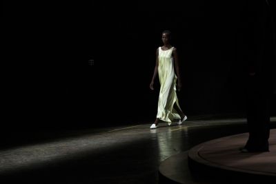 Woman on the runway wearing a light yellow maxi dress from the BOSS Womenswear Gallery Collection