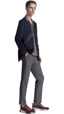 Man wearing blue jacket with grey trousers and red shoes by BOSS