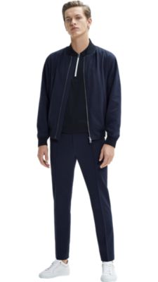 Man wearing a dark blue outerwear, dark blue t-shirt, dark blue trousers and white shoes by BOSS