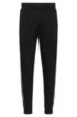 Cuffed-hem interlock-cotton trousers with logo-tape side seams, Black
