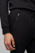 Slim-fit jogging trousers in moisture-wicking stretch fabric, Black