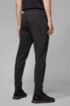Half-cuffed jogging trousers with curved logo, Black