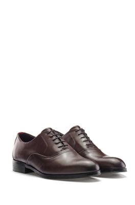Zapatos Oxford en piel pulida con detalle metálico Zapatos Oxford en piel pulida con detalle metálico