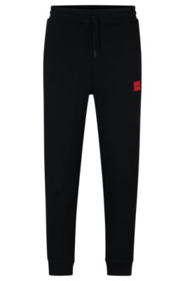 HUGO - Cotton-terry tracksuit bottoms with red logo label