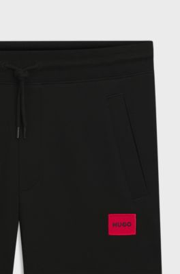 Cotton-terry tracksuit bottoms with red logo label, Black