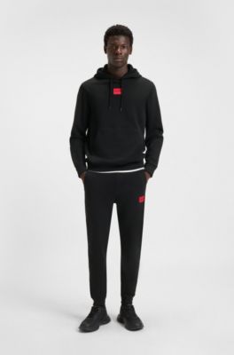 Cotton-terry tracksuit bottoms with red logo label, Black