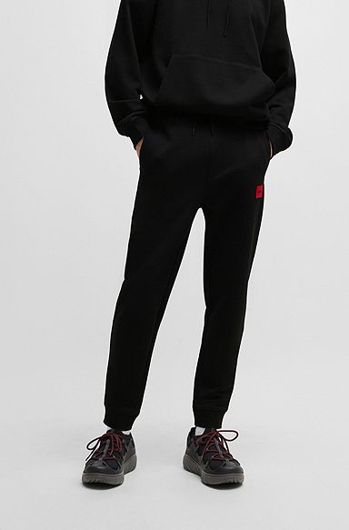 Cotton-terry tracksuit bottoms with red logo label, Black