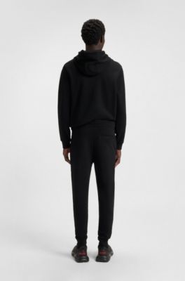 Cotton-terry tracksuit bottoms with red logo label, Black