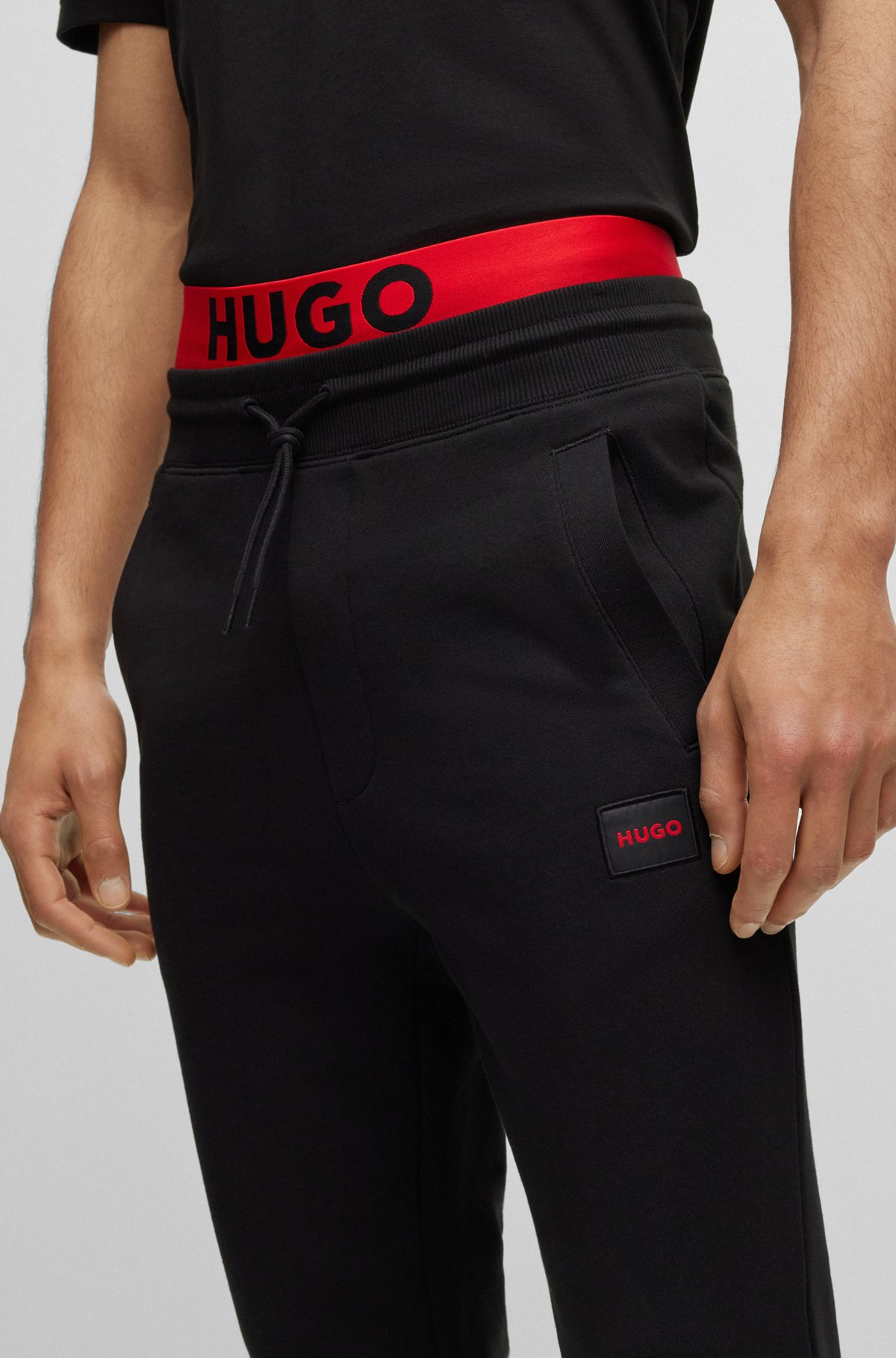 Cotton tracksuit bottoms with red logo patch, Black
