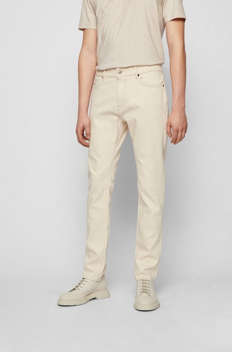 Jeans con fit affusolato in comodo denim elasticizzato in un colore naturale, Bianco