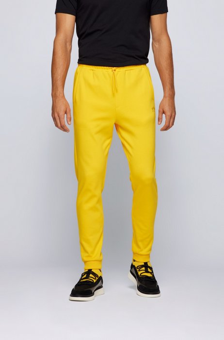Cuffed tracksuit bottoms in cotton with tonal piqué structure, Light Yellow