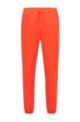 Cuffed tracksuit bottoms in cotton with tonal piqué structure, Orange
