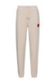 Cotton-terry tracksuit bottoms with logo label, Light Beige