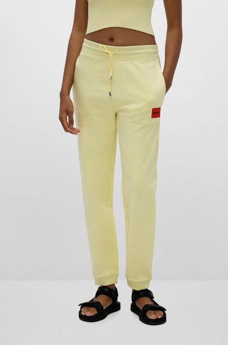 Cotton-terry tracksuit bottoms with logo label, Light Yellow