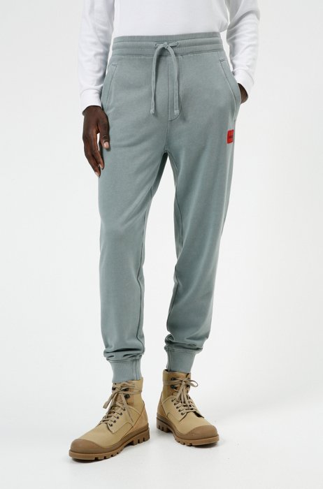Tracksuit bottoms in terry cotton with red logo label, Light Blue