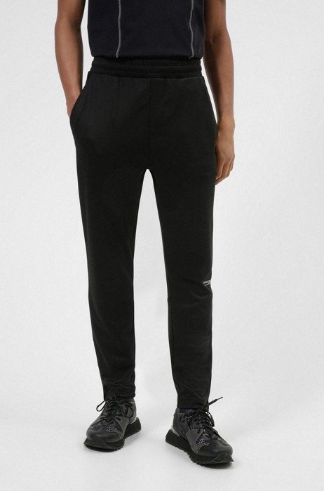 Tracksuit bottoms in performance-stretch twill with structured inserts, Black