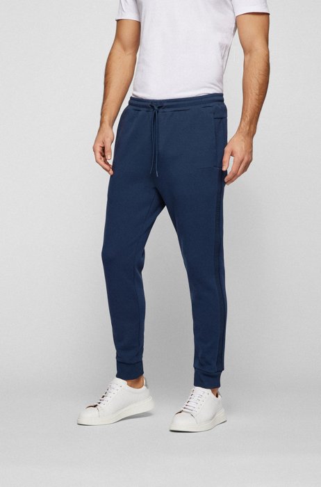 Cuffed cotton-blend tracksuit bottoms with tonal logo tape, Dark Blue