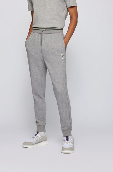 Melange-cotton tracksuit bottoms with embroidered patch, Grey