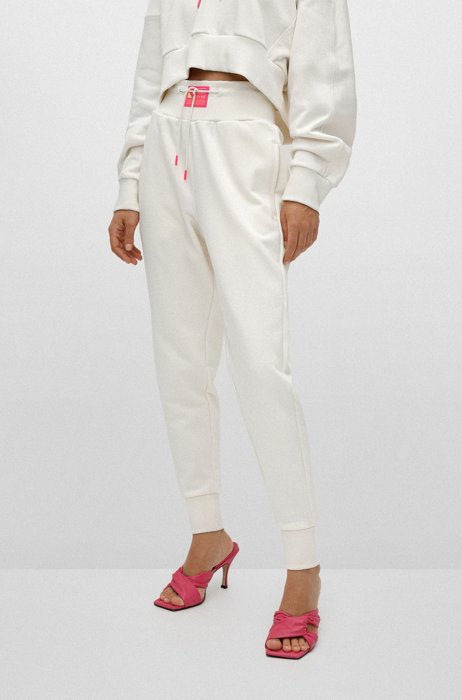 Cotton-blend tracksuit bottoms with neon-pink capsule logo, White