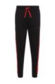 Cotton tracksuit bottoms with red logo tape, Black