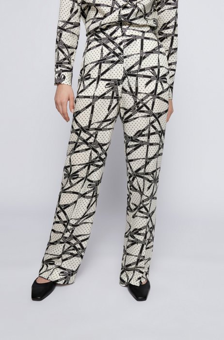 Pantaloni relaxed fit in TENCEL™ Lyocell con stampa di un nastro brandizzato, A disegni