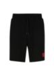 Shorts aus French-Terry-Baumwolle mit rotem Logo-Etikett, Schwarz