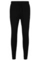 Cotton tracksuit bottoms with curved logo, Black