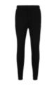Organic-cotton tracksuit bottoms with curved logo, Black