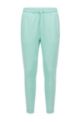 Organic-cotton tracksuit bottoms with curved logo, Light Green