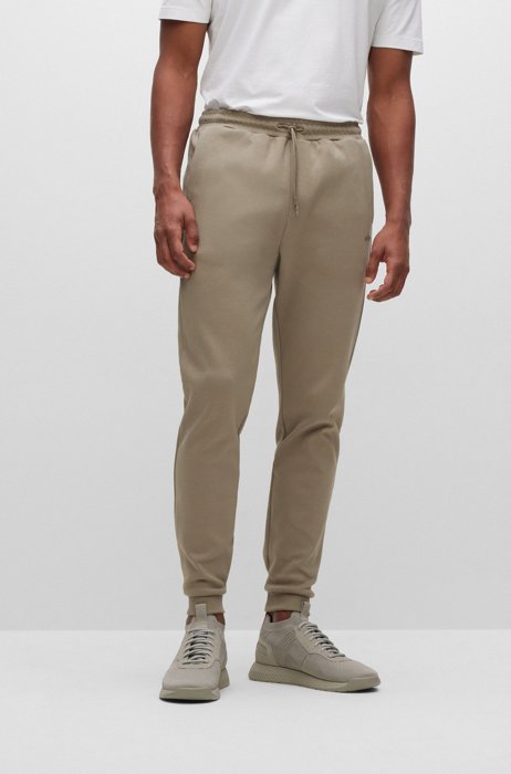 Cotton tracksuit bottoms with curved logo, Beige