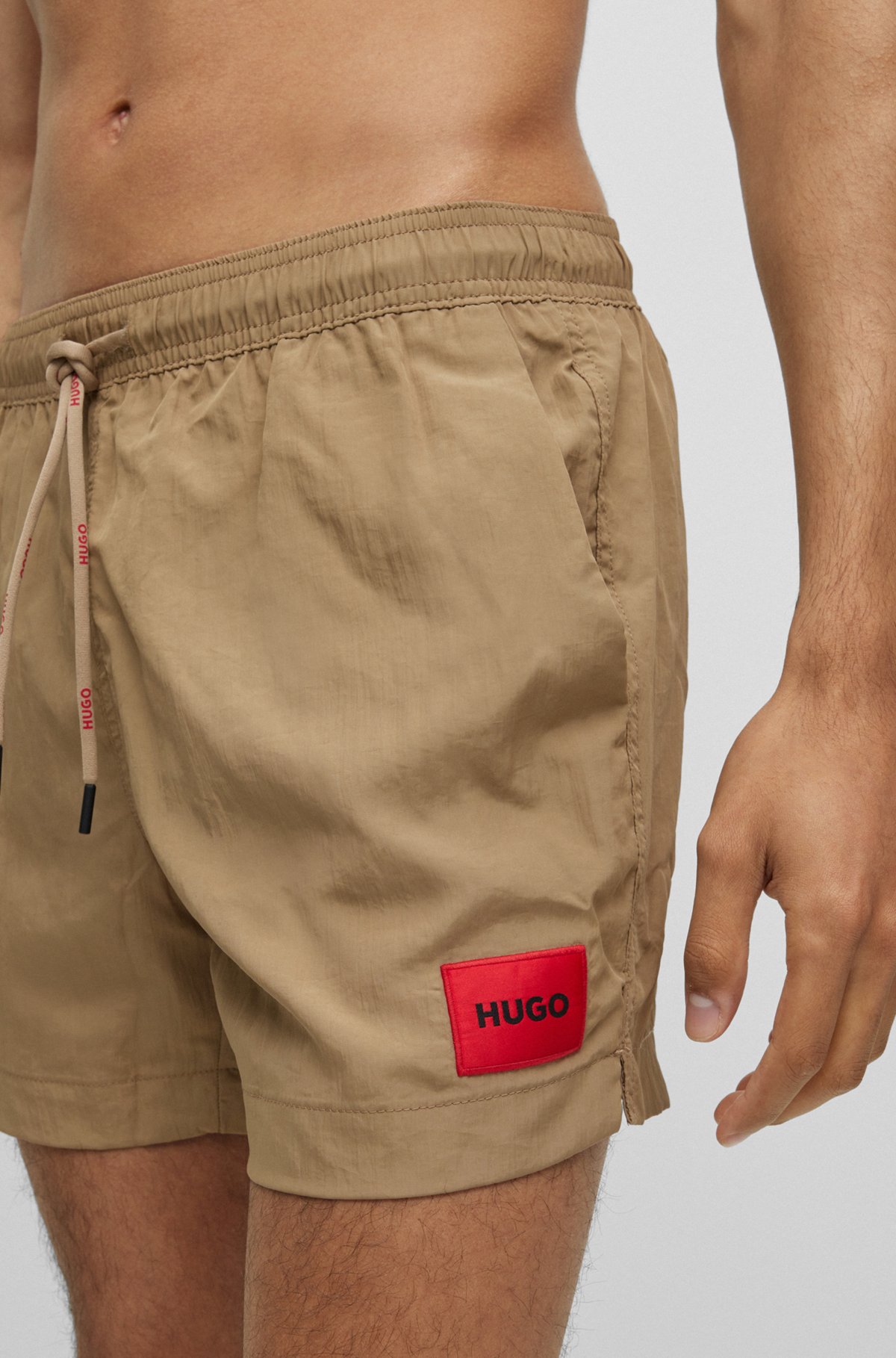 Quick-dry swim shorts with red logo label, Light Brown