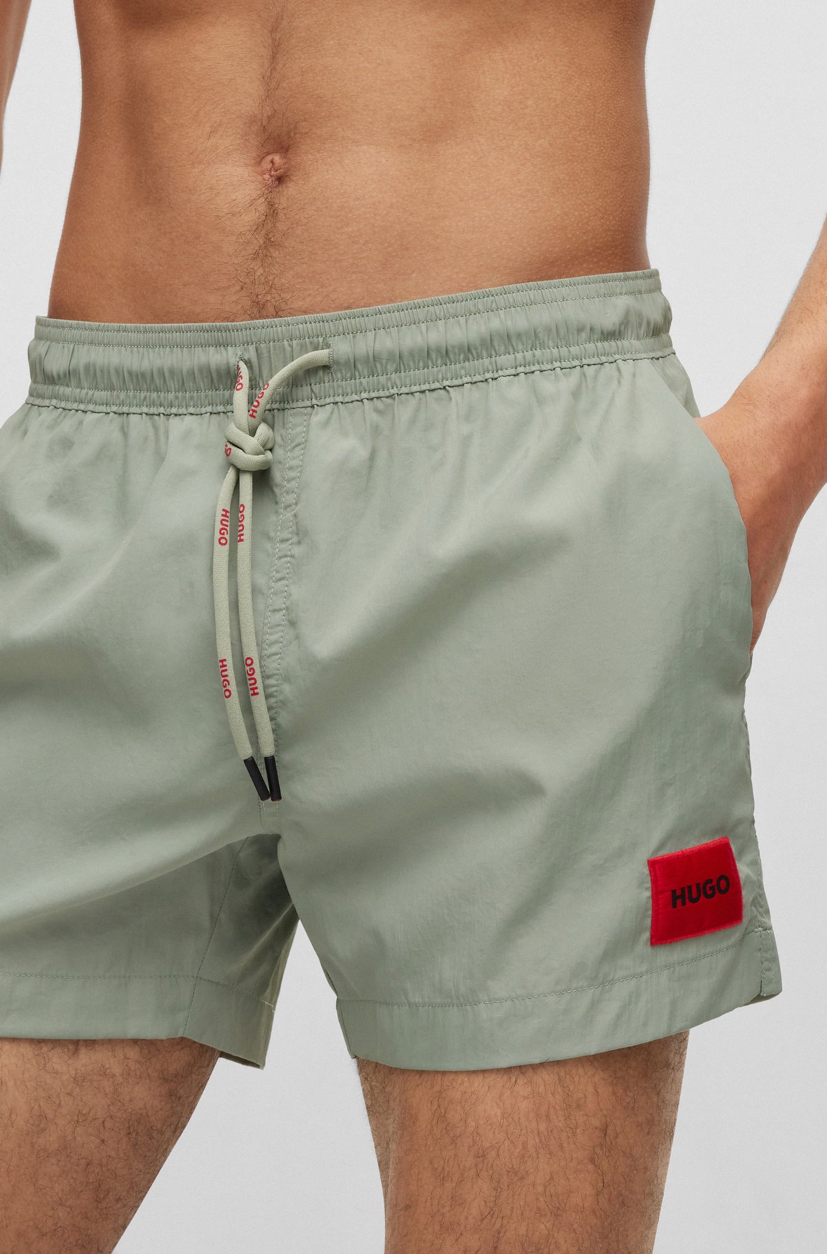 Quick-dry swim shorts with red logo label, Light Green