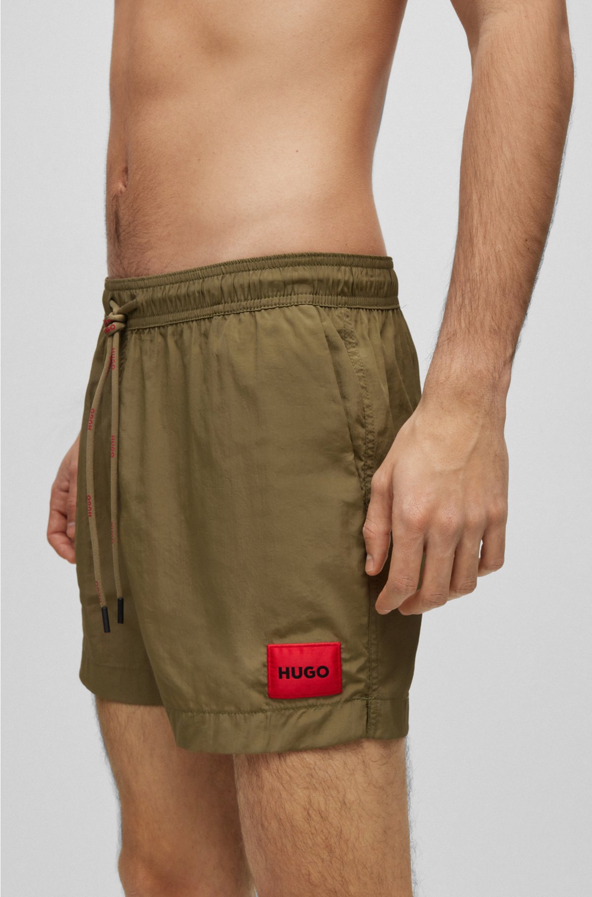 Quick-dry swim shorts with red logo label, Green