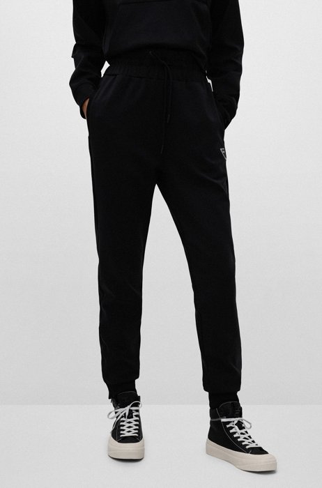 Tapered-fit tracksuit bottoms with silicone logo, Black