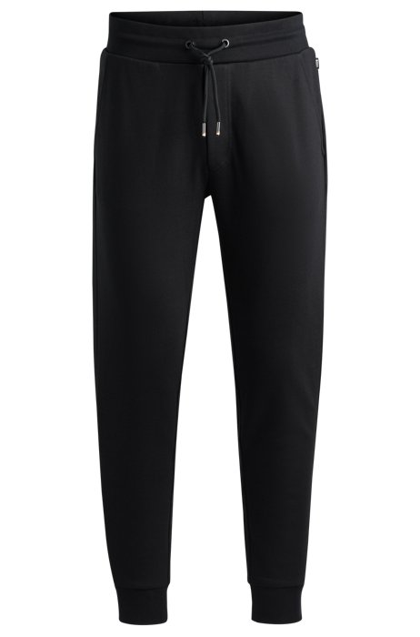 Organic-cotton tracksuit bottoms with rubber-print logo, Black