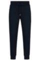 Organic-cotton tracksuit bottoms with rubber-print logo, Dark Blue